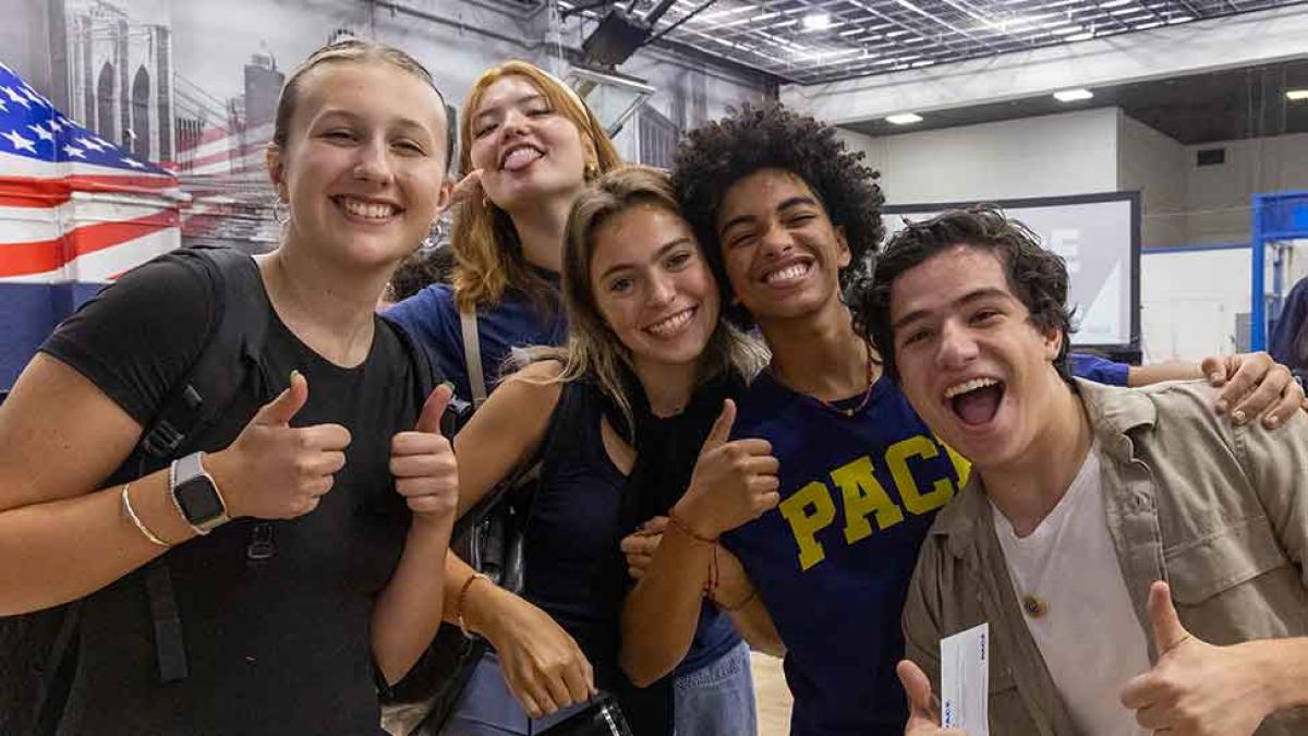 Pace students smile and thumbs up at Convocation