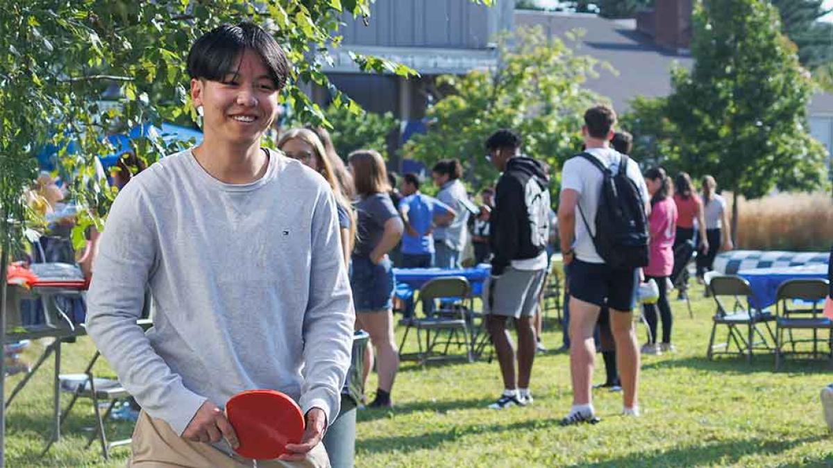 A Pace student holding a ping pong paddle at Pleasantville's Campus