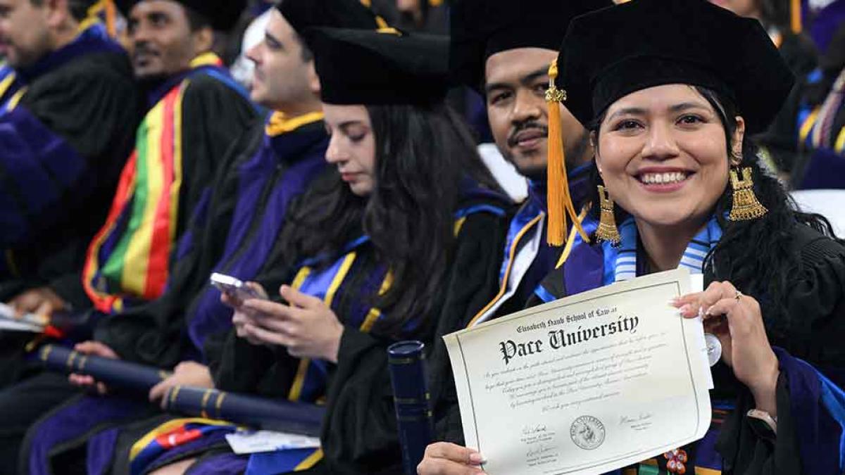 Student holding diploma at commencement 