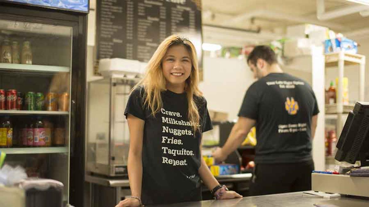 a Pace University student smiles at her on campus job