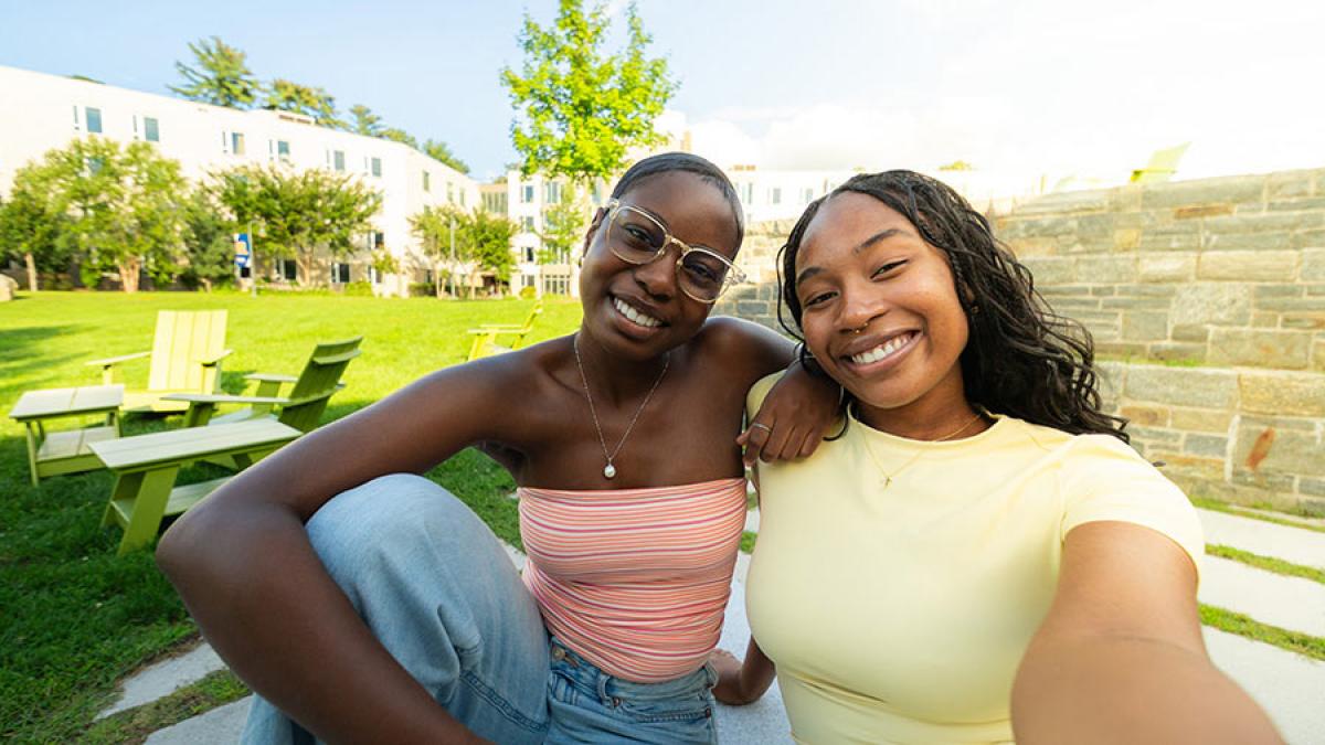 Two Pace University students smiling at the camera on the Westchester campus.