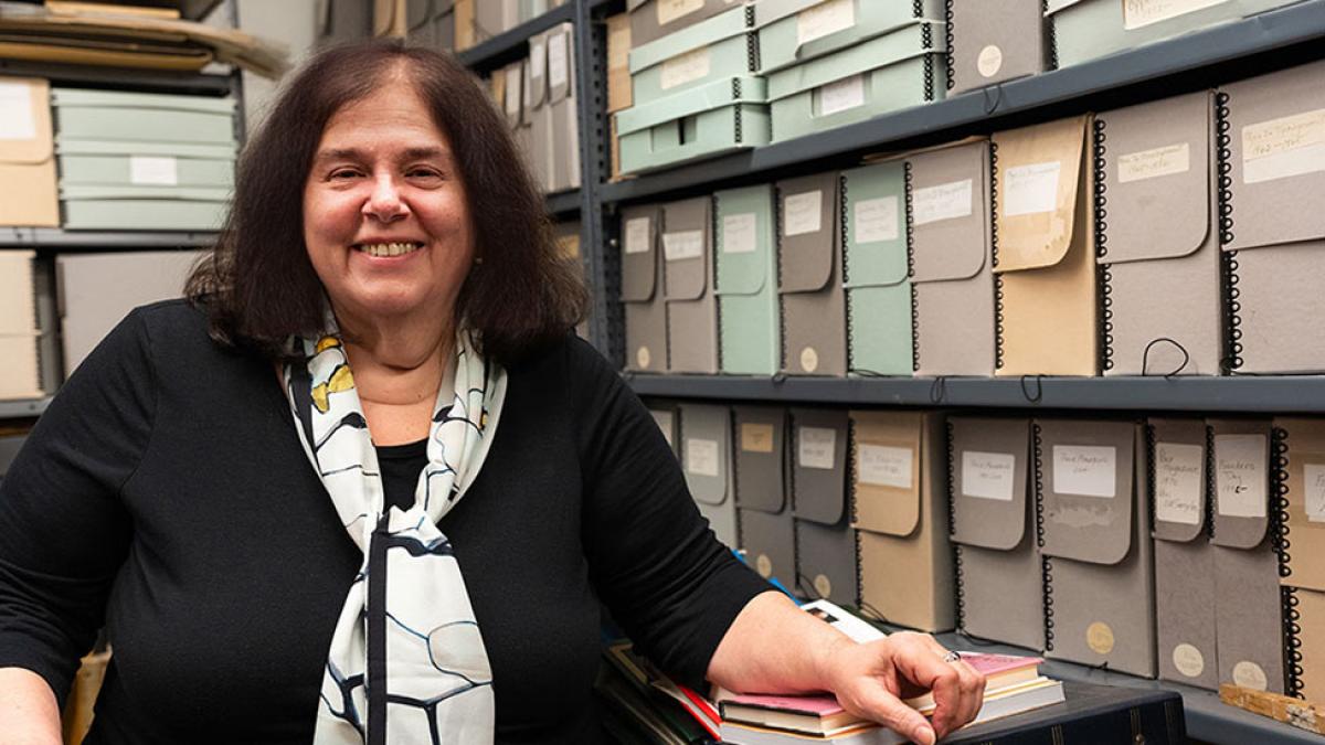 Ellen Sowchek stands in front of rows of organized files