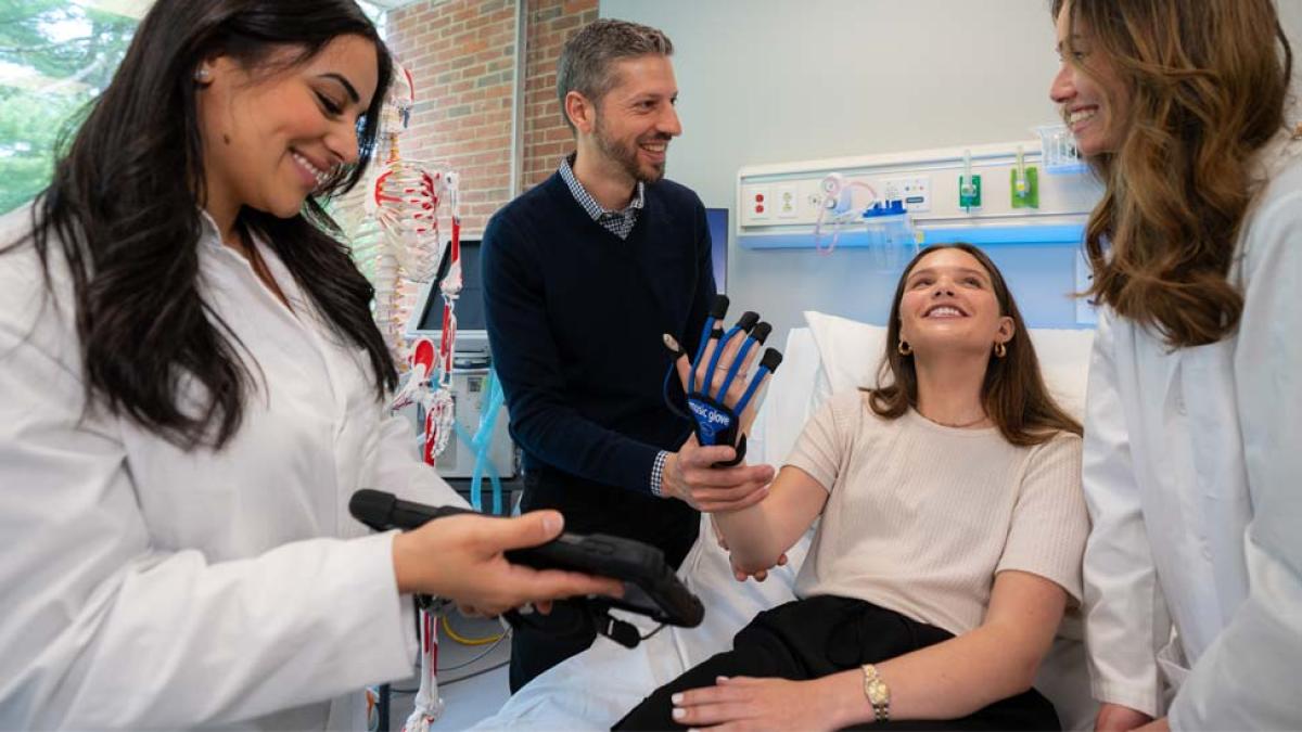 OT students and faculty working in a simulation lab.