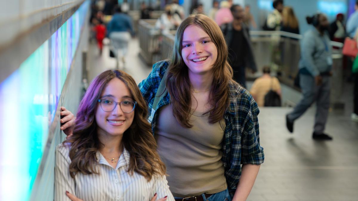 Two Pace University students smiling at the camera.