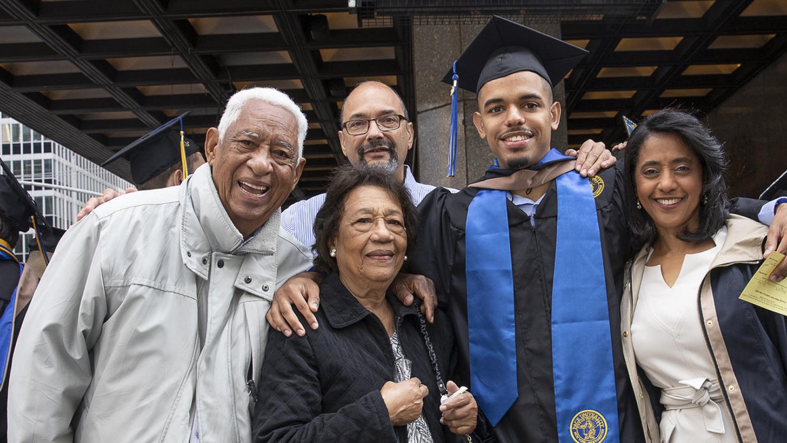 A family with their recent Pace University Grad outside of the Commencement ceremony in New York City