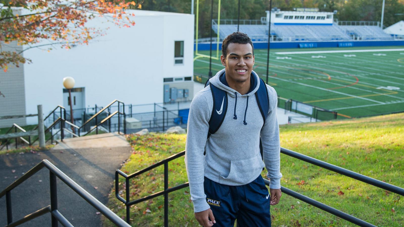 Student athlete leaving the football field on the Westchester campus.