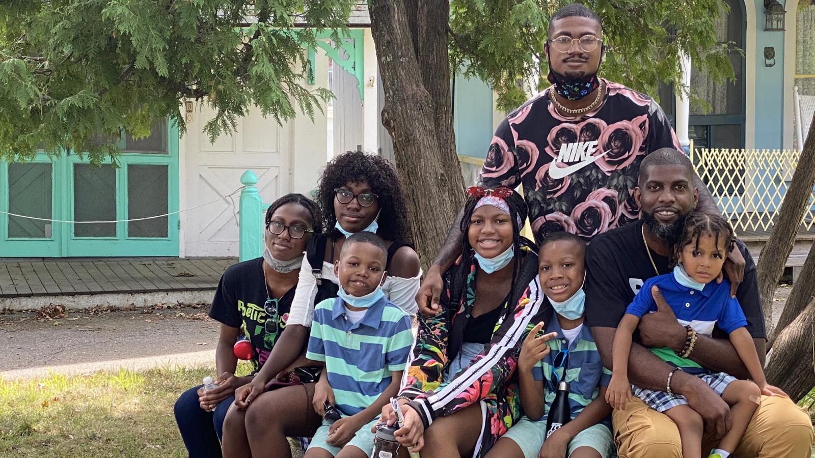 Large family sitting under a tree