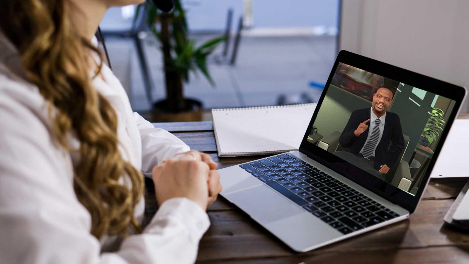 woman looking at an open laptop screen