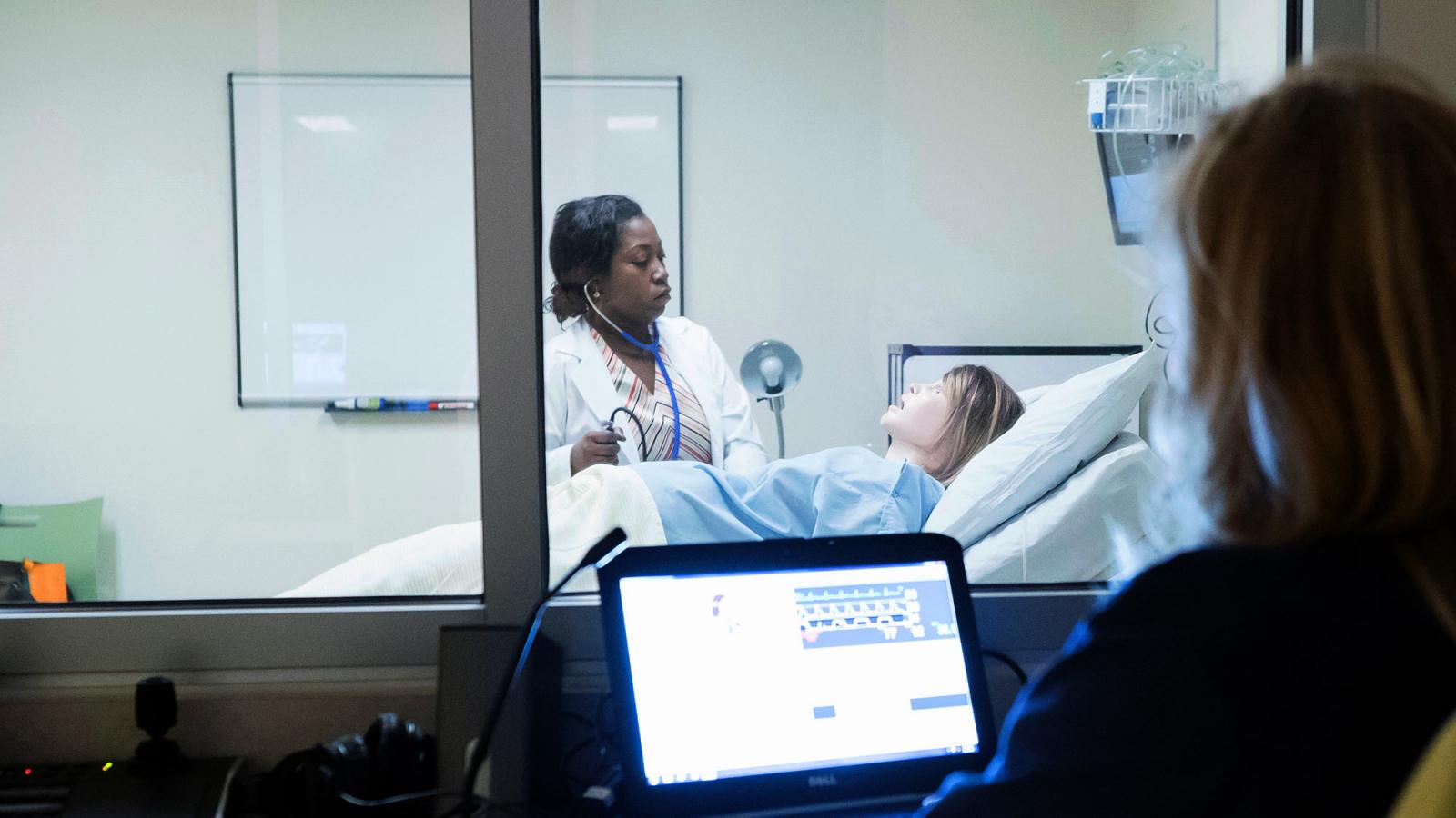 Nursing student working with a dummy.