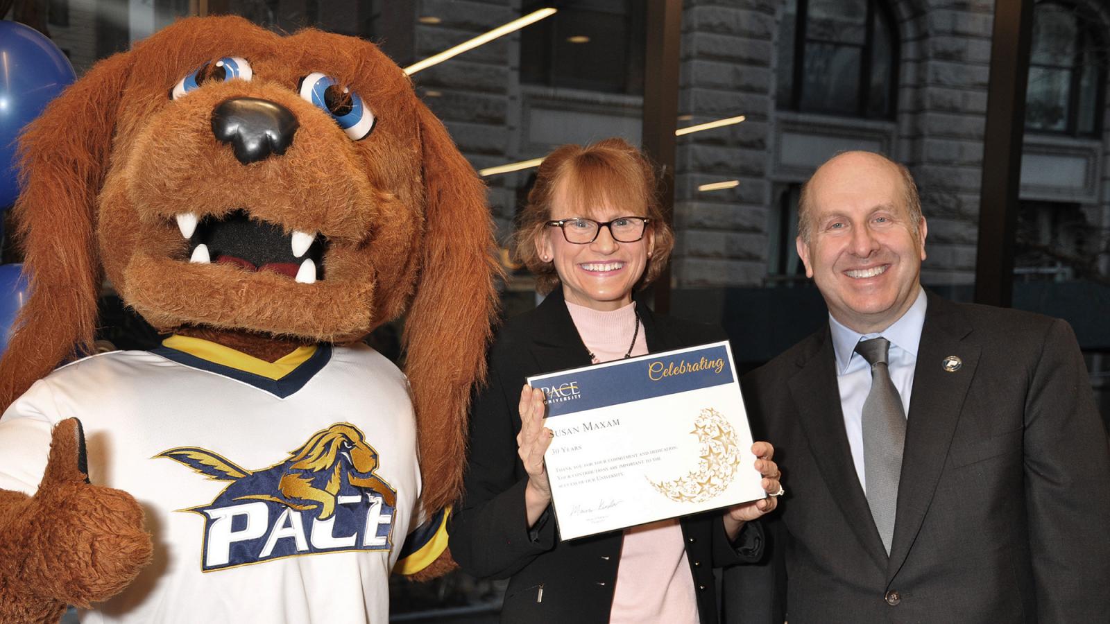 Sue Maxam receiving an award from President Krislov.