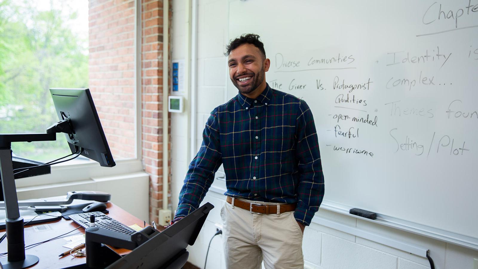 Student teacher teaching in a classroom in front of the board.