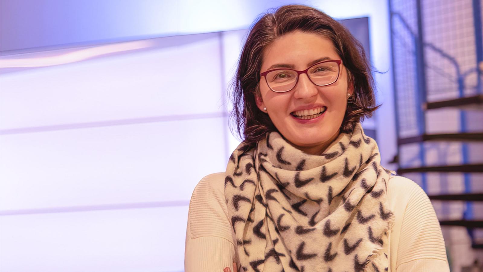 woman with dark hair and glasses