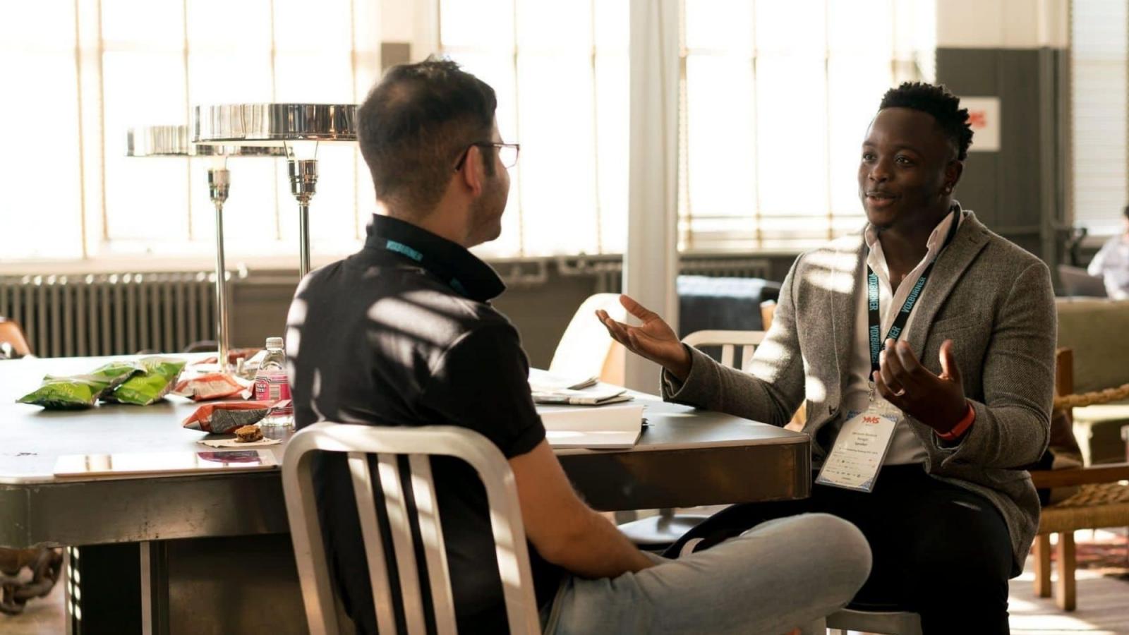 two men having a conversation at a table