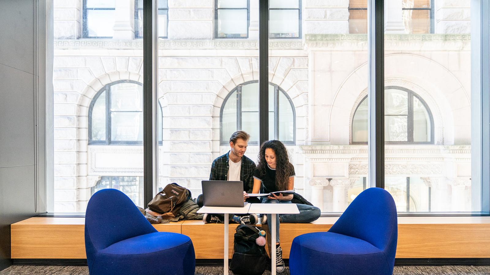 Students sitting at a table studying.