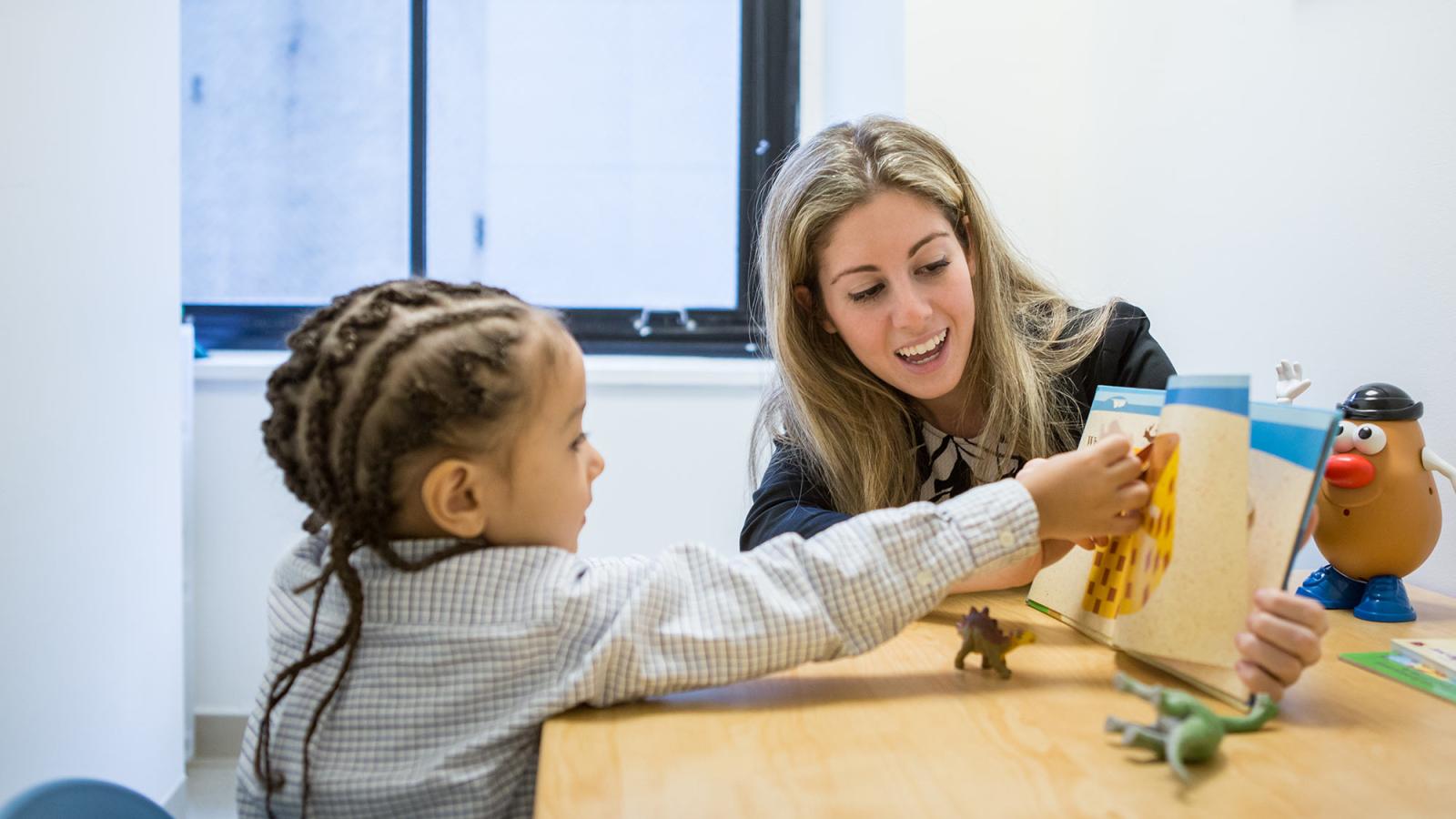 Student working with a young patient at the Speech, Language, and Hearing Center at Pace University.