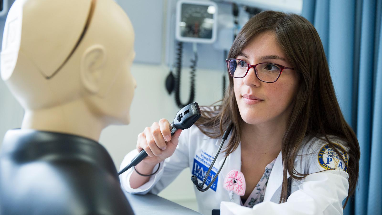 Physician Assistant student working with a mannequin in the simulation lab.