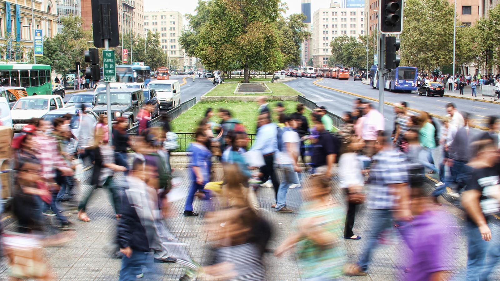 Blurry people crossing a busy intersection