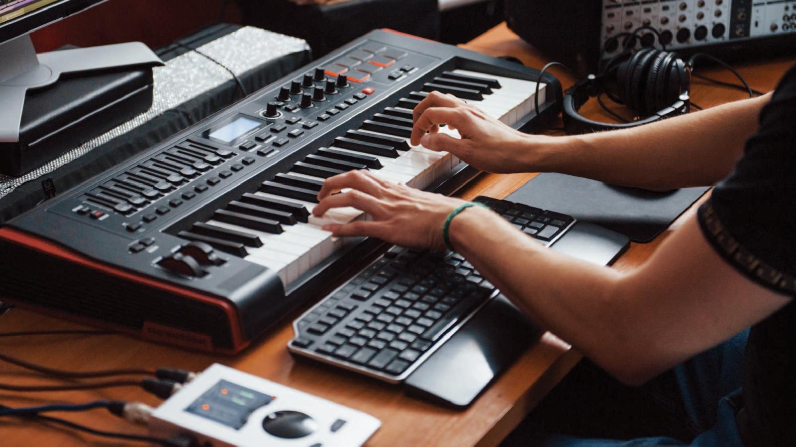 person using a midi keyboard