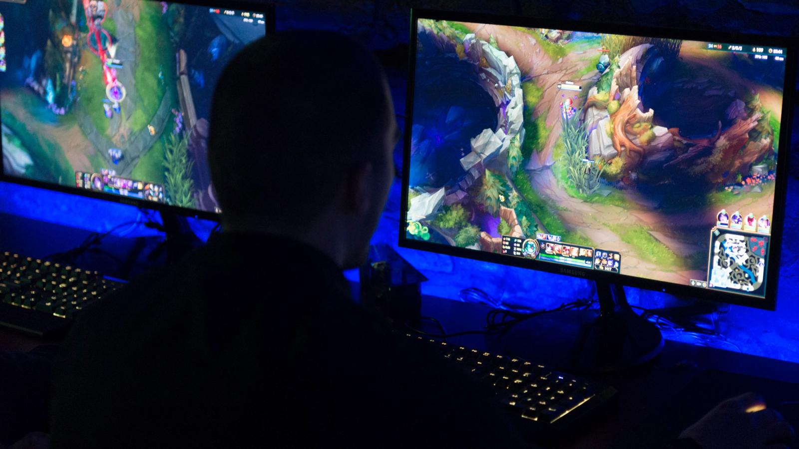 person playing league of legends on a computer