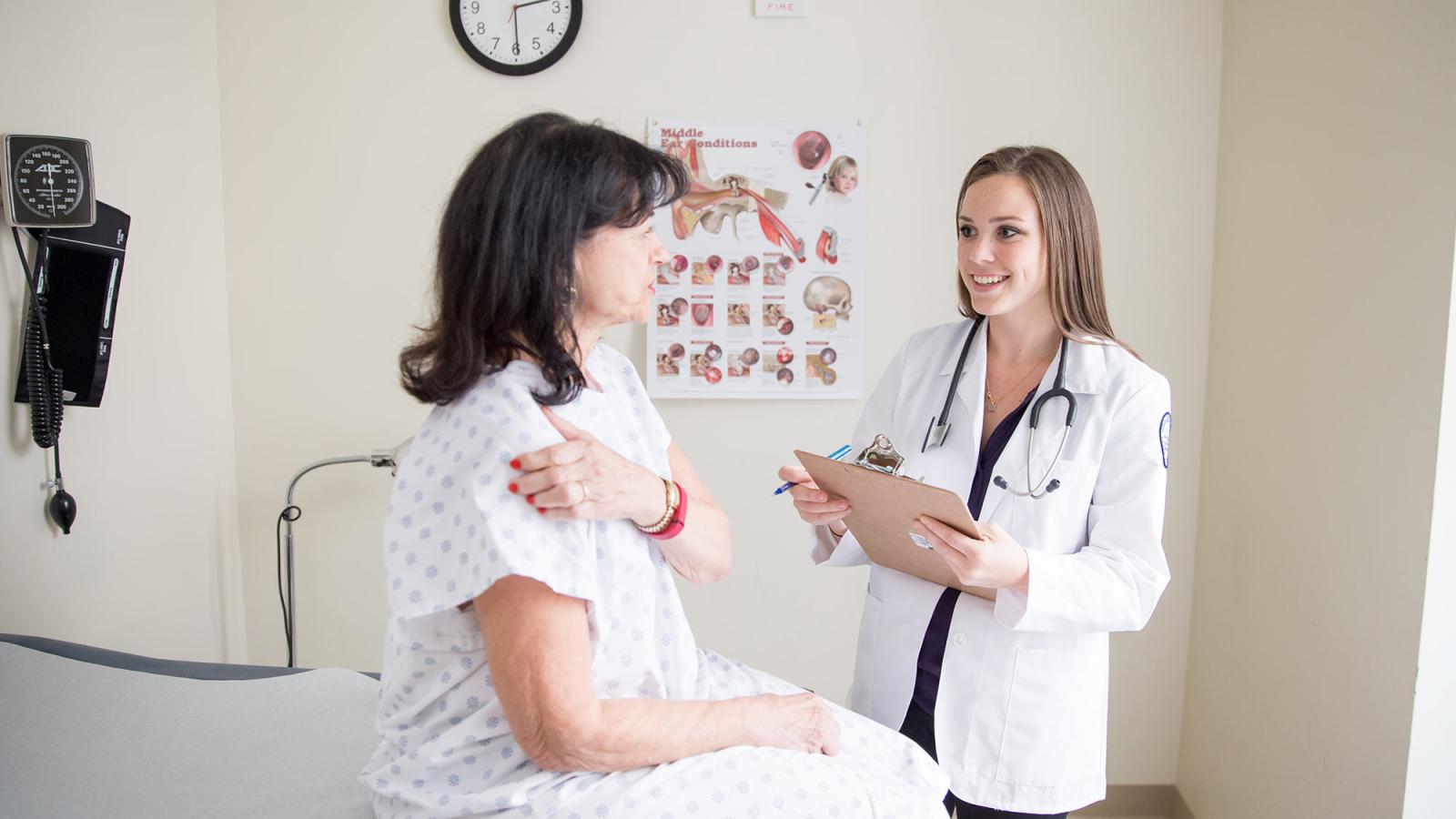 Colloge of Health Professions student working with a patient in a clinical setting.