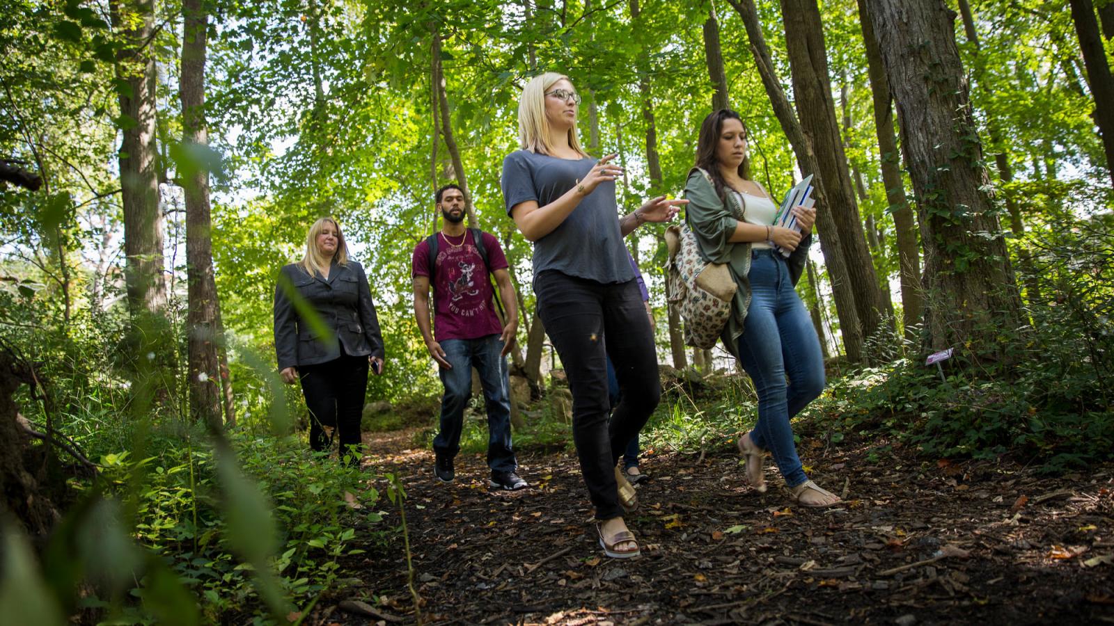 Students on a wooded trail near the Pleasantville campus