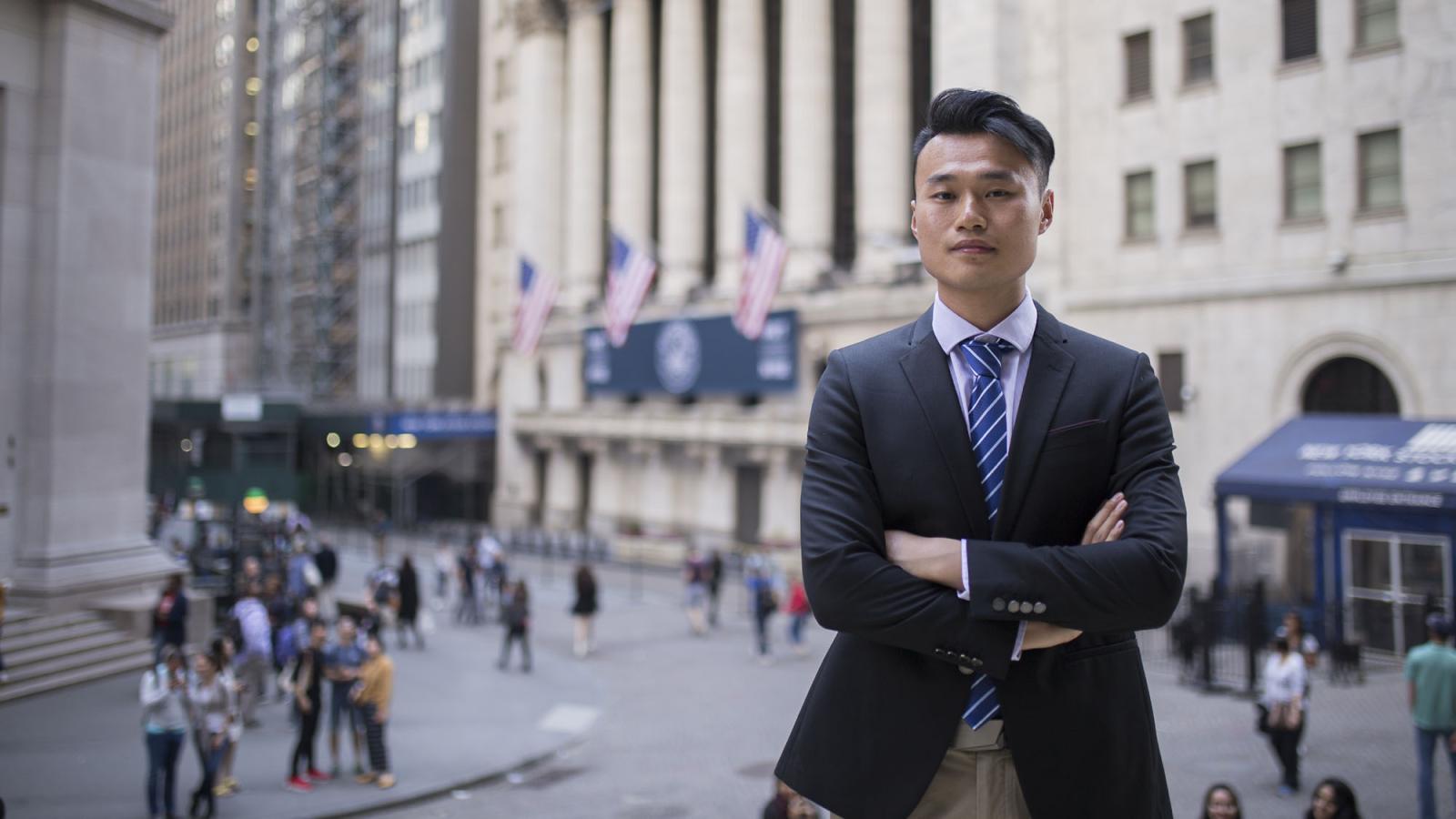 Lubin student in business attire standing in Lower Manhattan's Financial District