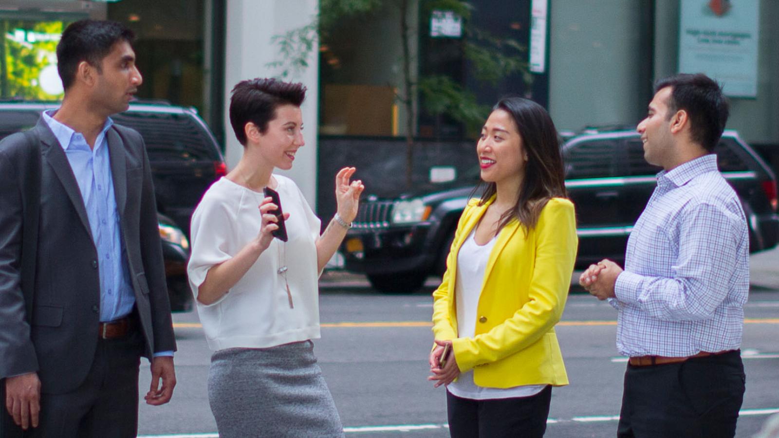 four Lubin graduate students walking in Lower Manhattan near the New York City Campus