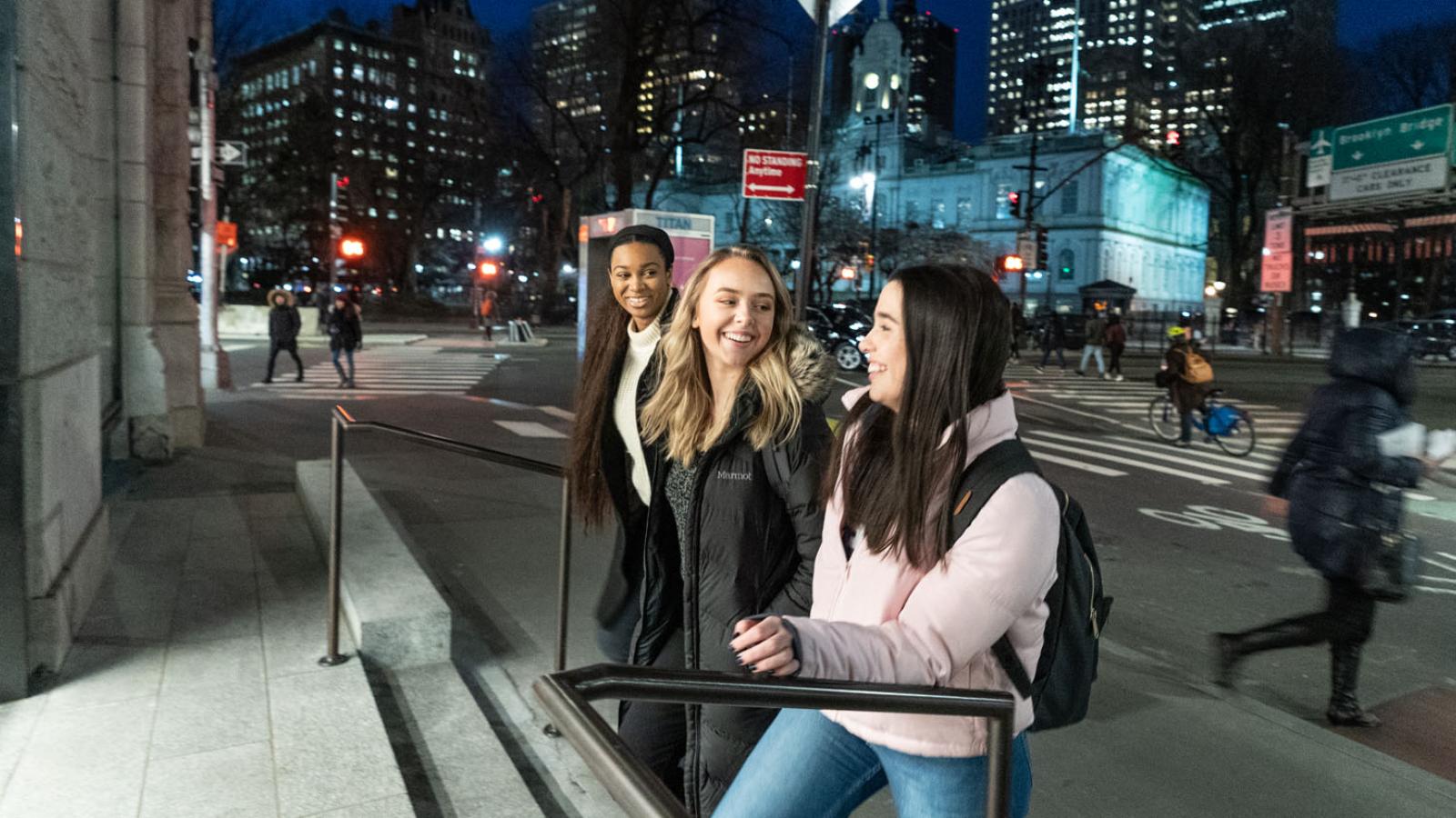 three Pace students walking into 41 Park Row on the New York City Campus in Lower Manhattan