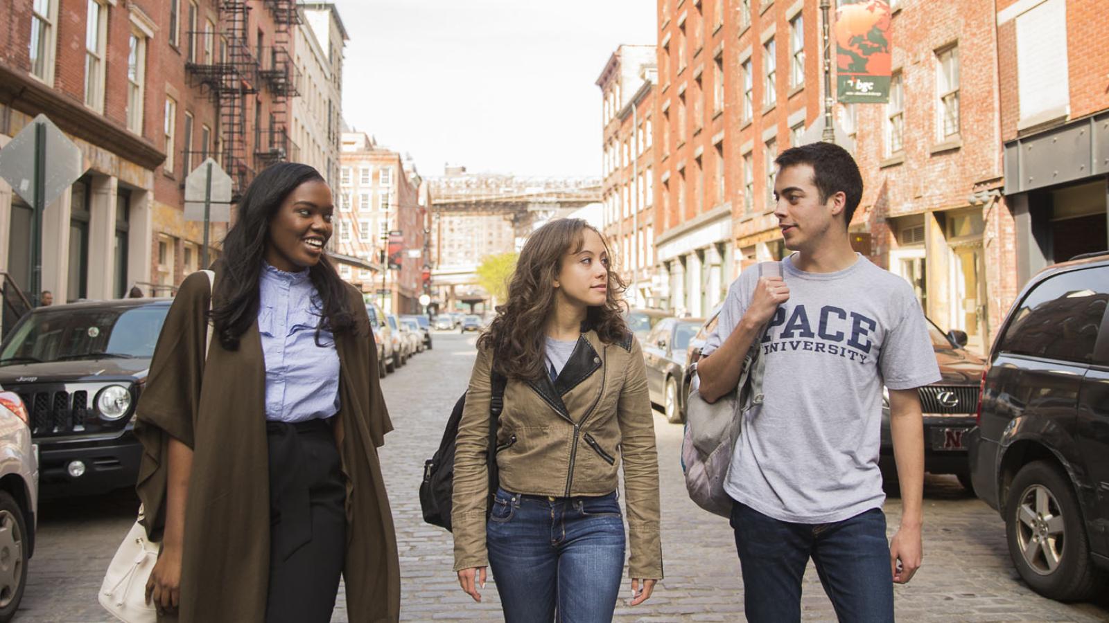 three Pace University students walking in the Seaport district of Lower Manhattan
