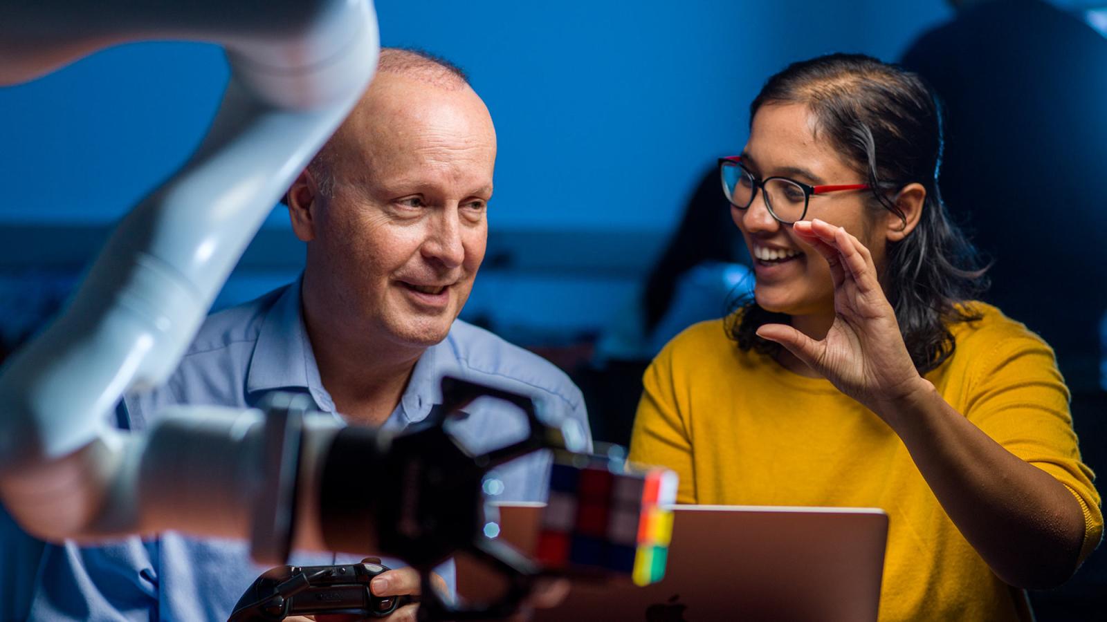 Seidenberg faculty member working on a project with a student.