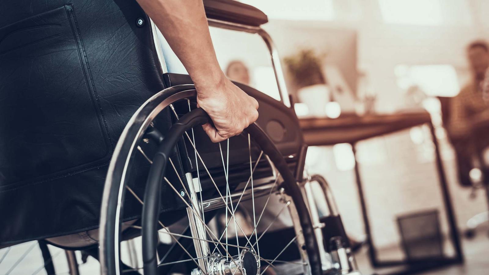 close up on man's arm utilizing wheelchair