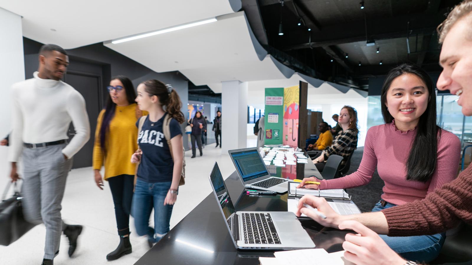 Students walking through the front of 1 Pace Plaza