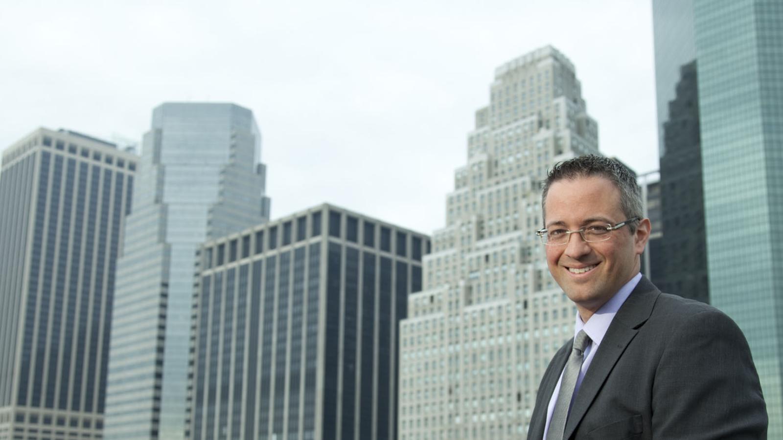 man in business attire sitting in Lower Manhattan near Pace University's New York City Campus