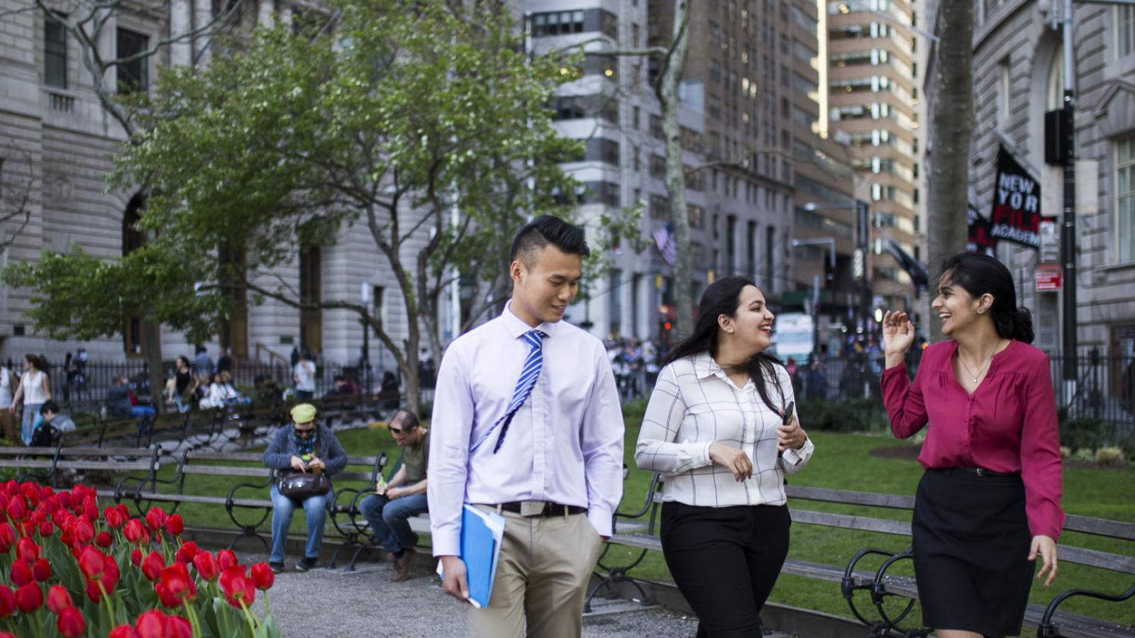 three Lubin graduate students walking in Lower Manhattan near Pace University's New York City Campus