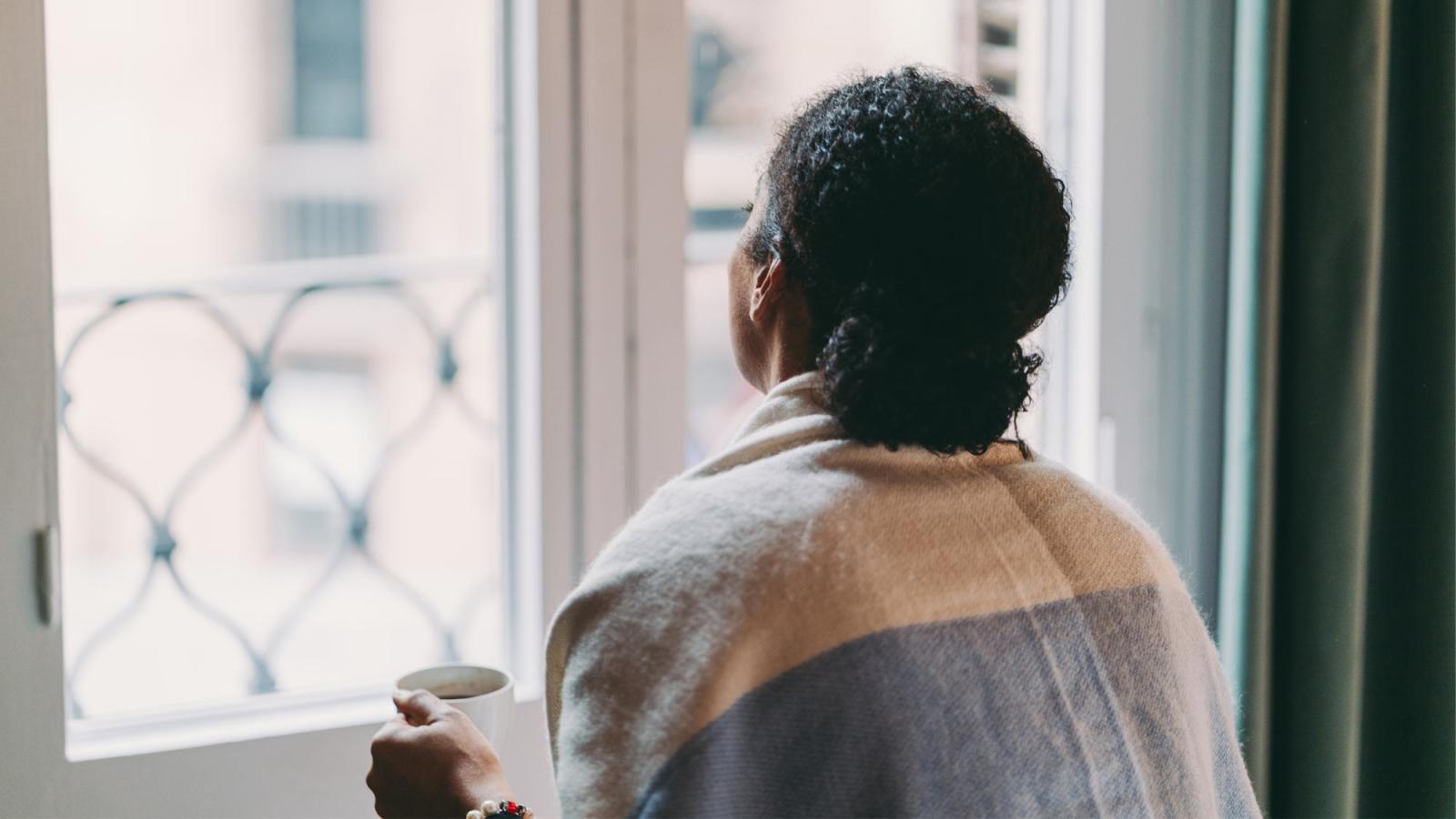 woman looking out window