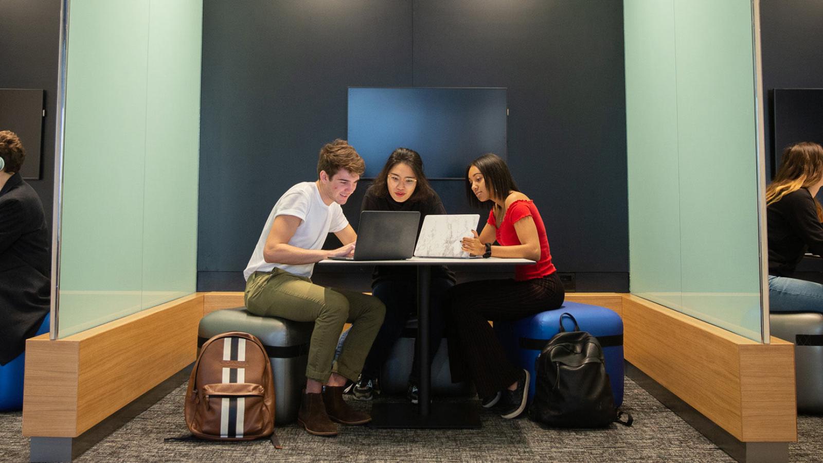 Students sitting at a table studying.