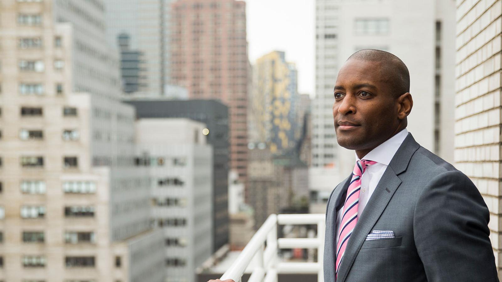 EMBA graduate looking at the Manhattan skyline.