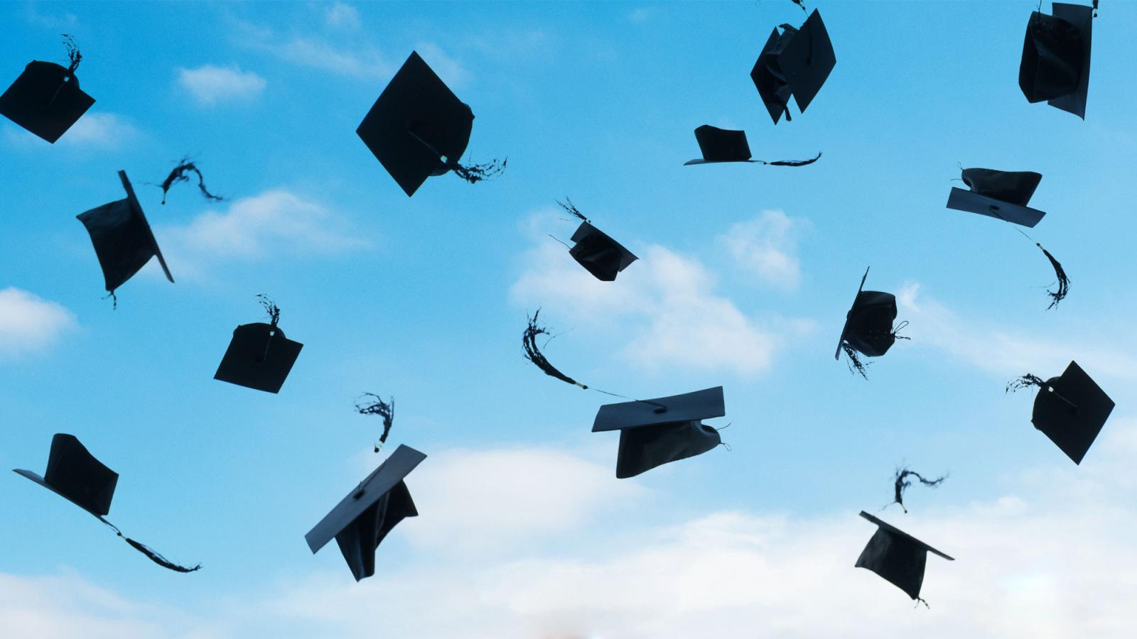 mortar board caps in air