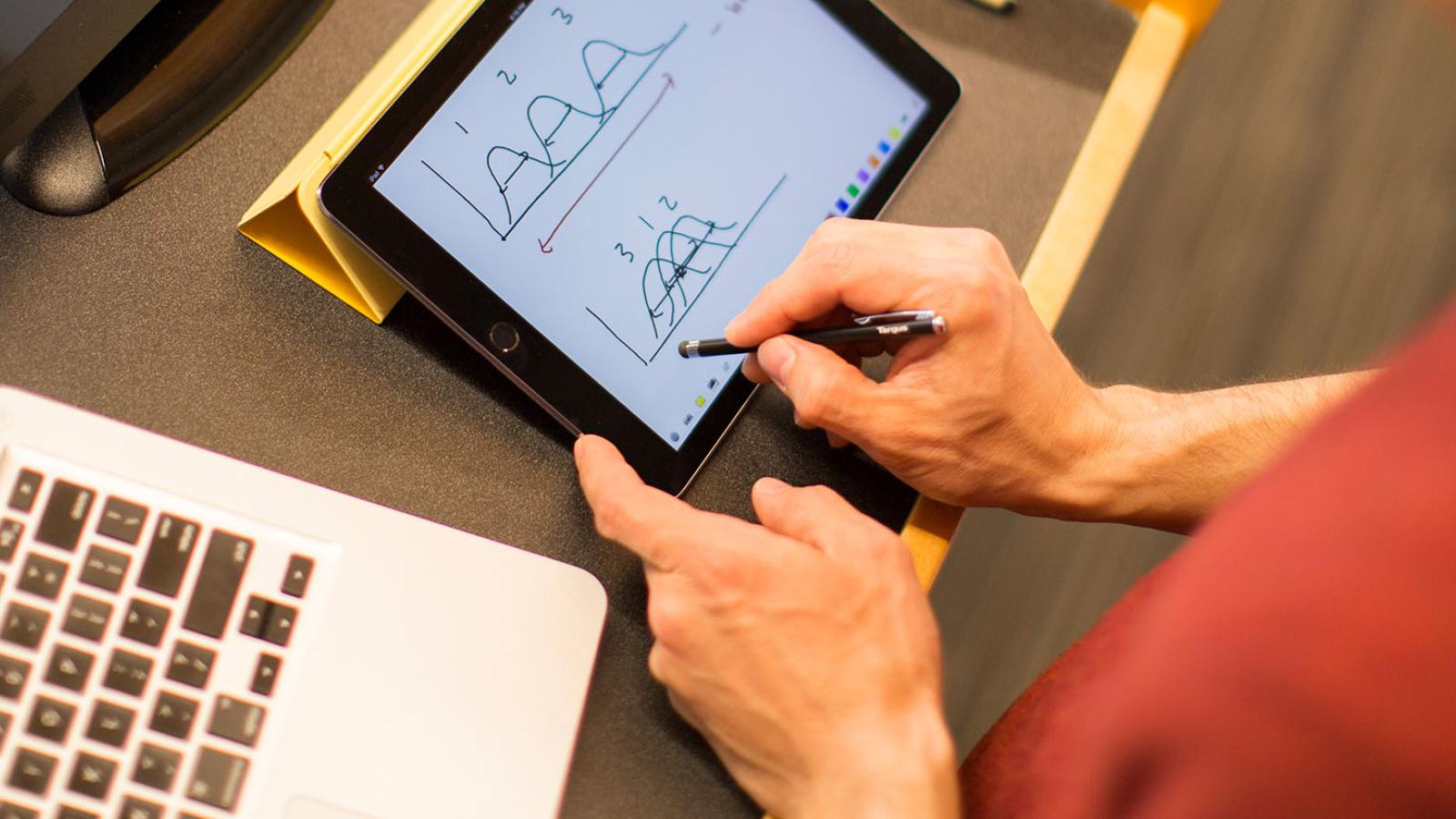 Faculty member working on graphics through a tablet