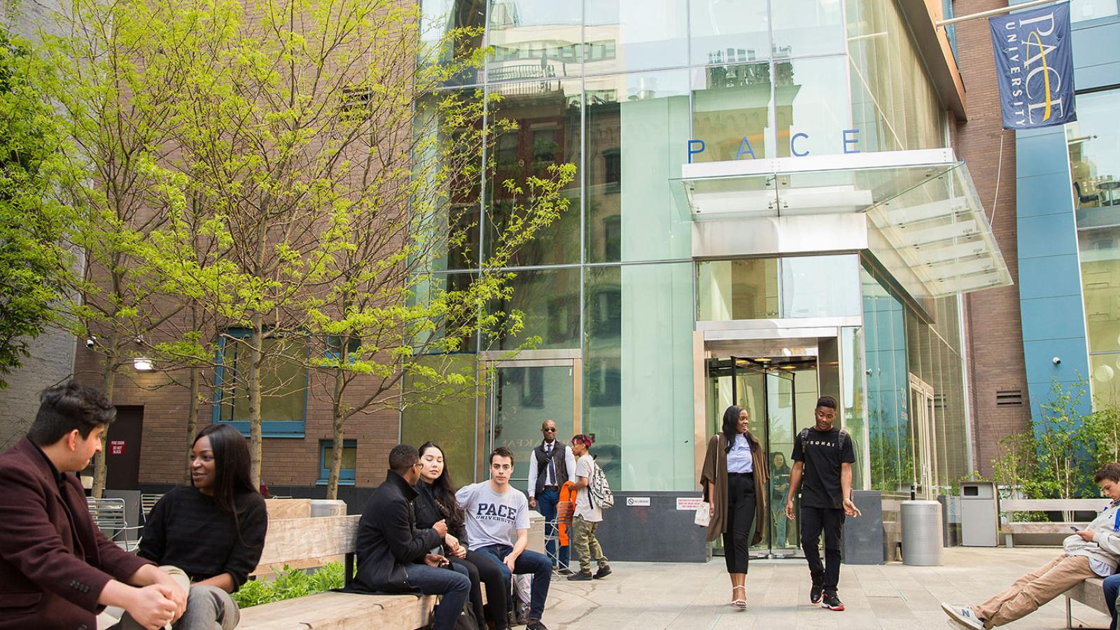 Students walking out of a residential hall at the NYC campus