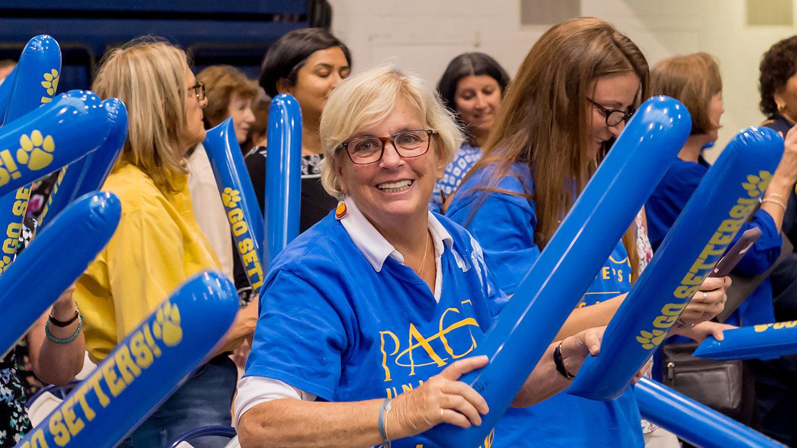 Staff members smiling at the camera.