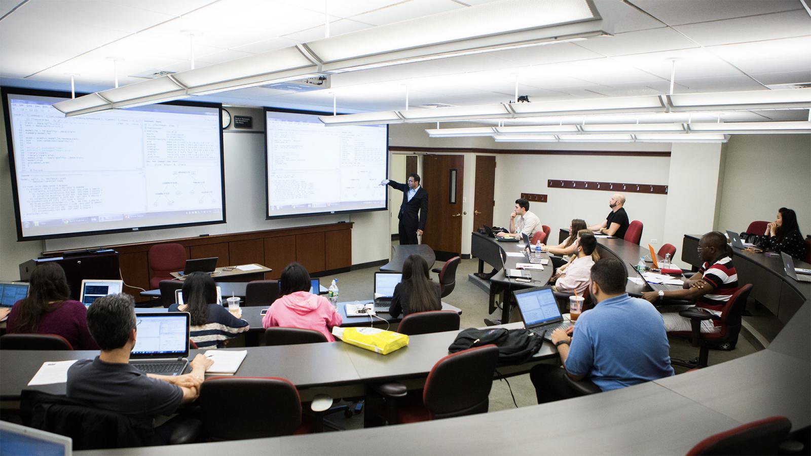 Students and Professor using technology to enable learning.