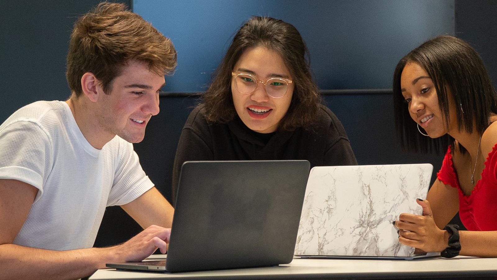 Pace University students looking at their laptop computers