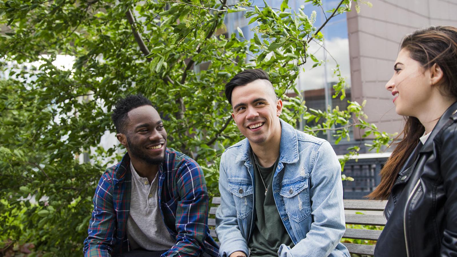 Three Pace Students sitting on a bench and talking