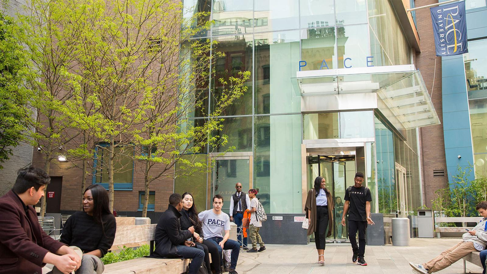 Group of students walking out of a residential hall on the NYC campus.