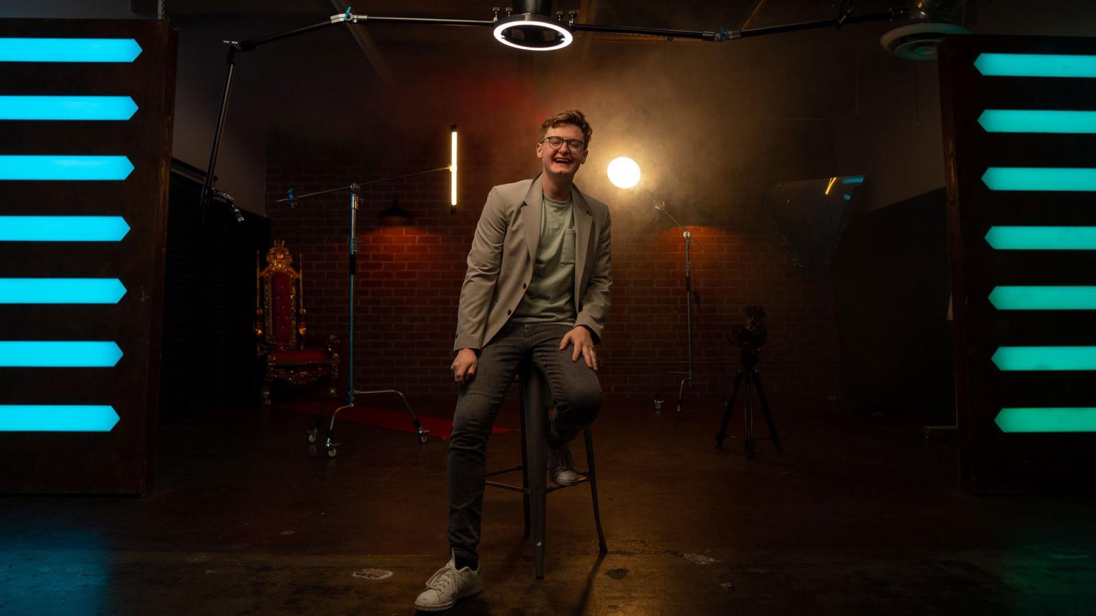 young man in a suit standing on a stage