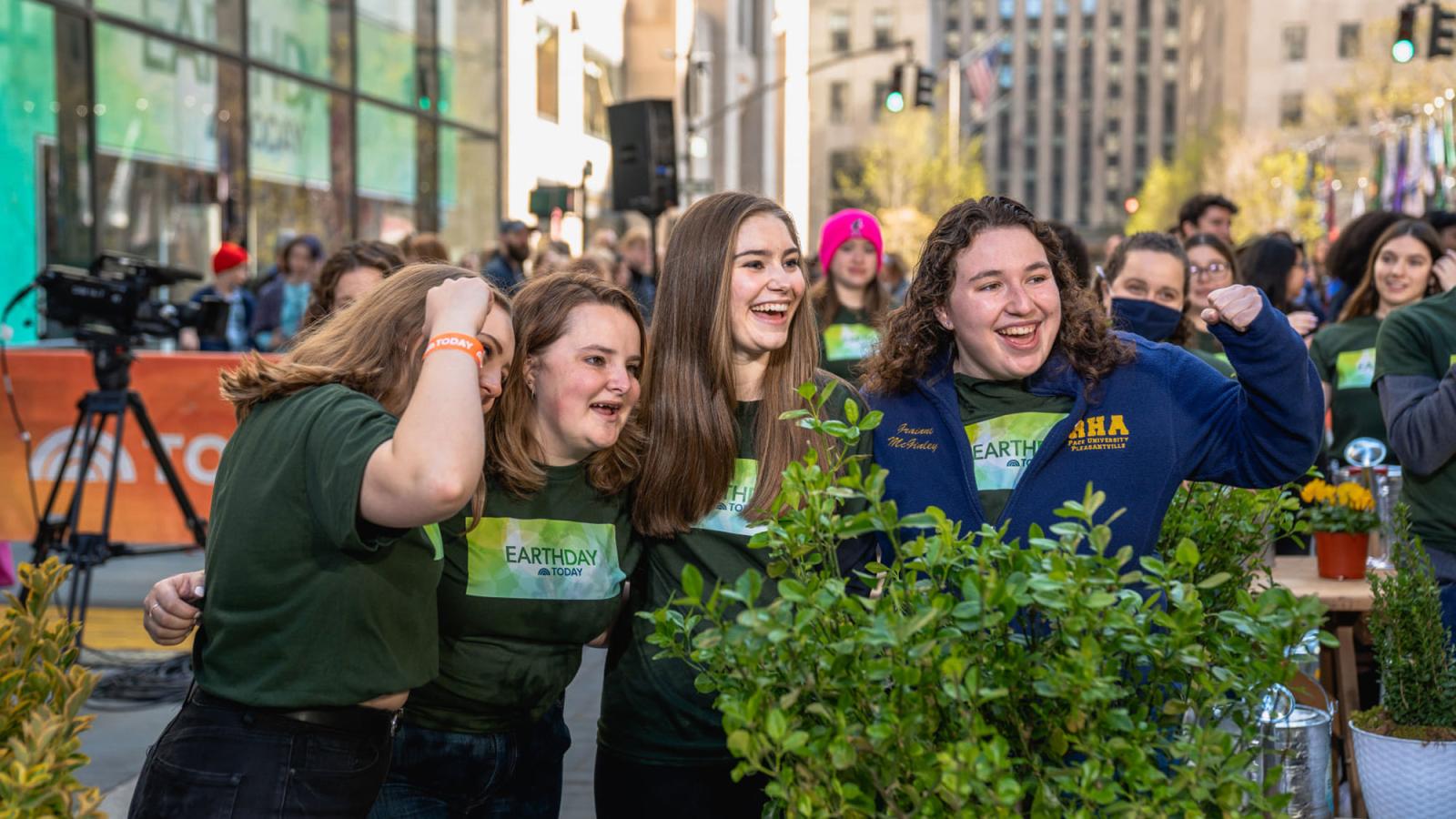 women smiling with a plant