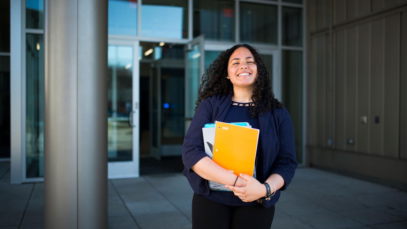 Student smiling while walking out of the Kessel Student Center.