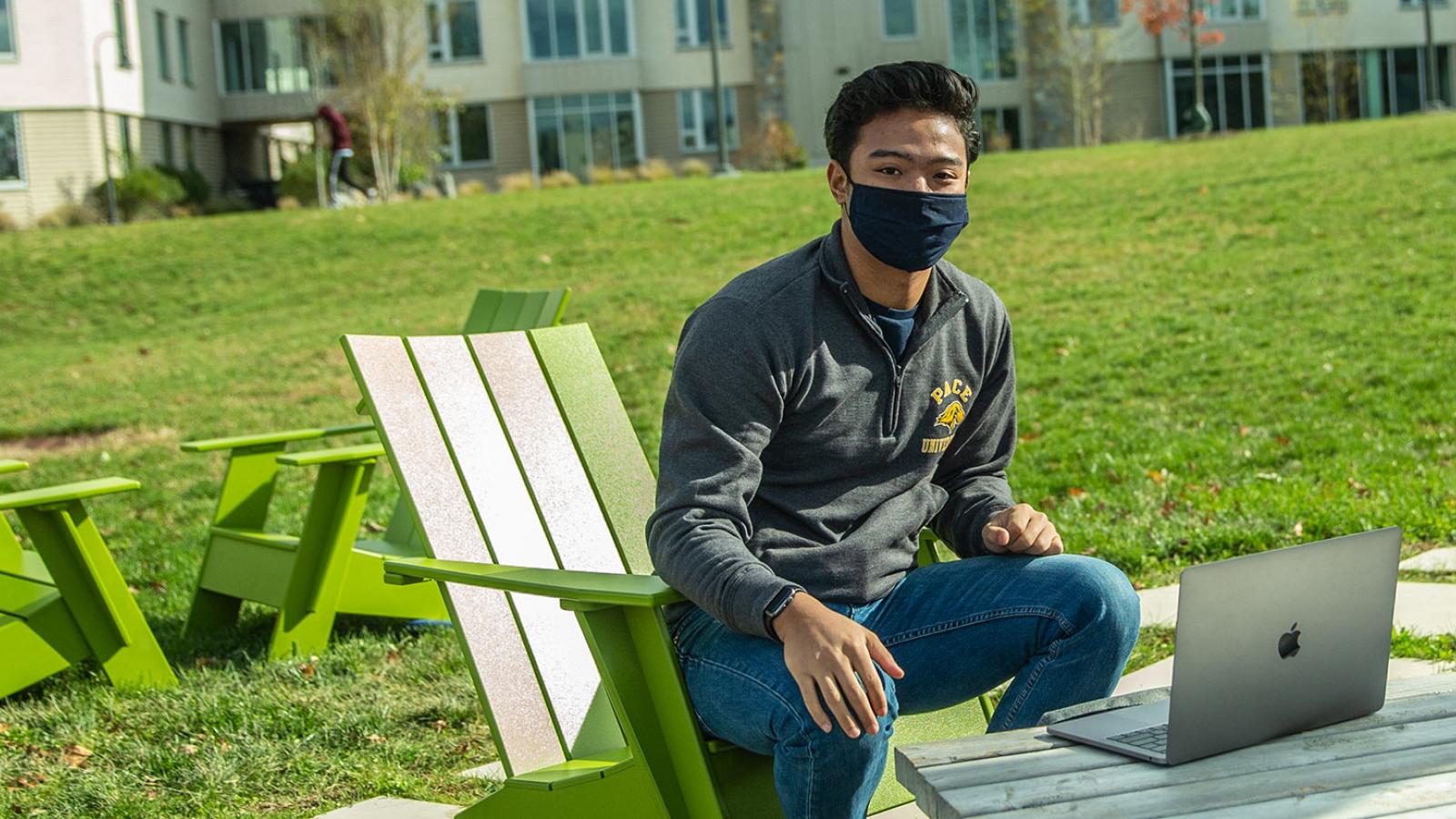 Pace student using a laptop outdoors