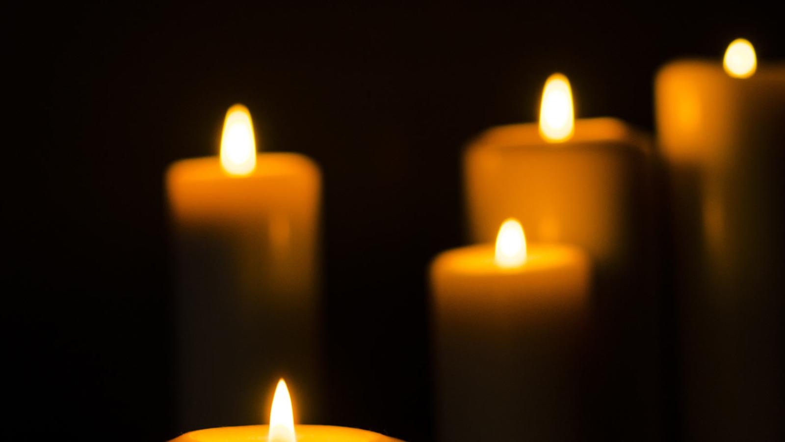 Lit candles on a black background